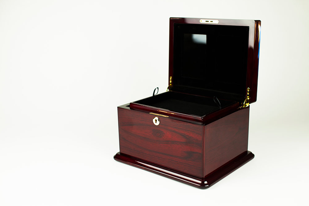 This beautiful memorial is both a cremation urn and a keepsake chest ...