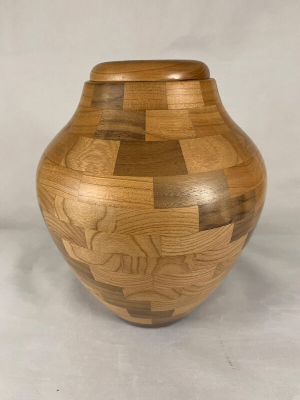 Solid wood urn handcrafted in the USA from Cherry and Walnut wood segments turned on a lathe